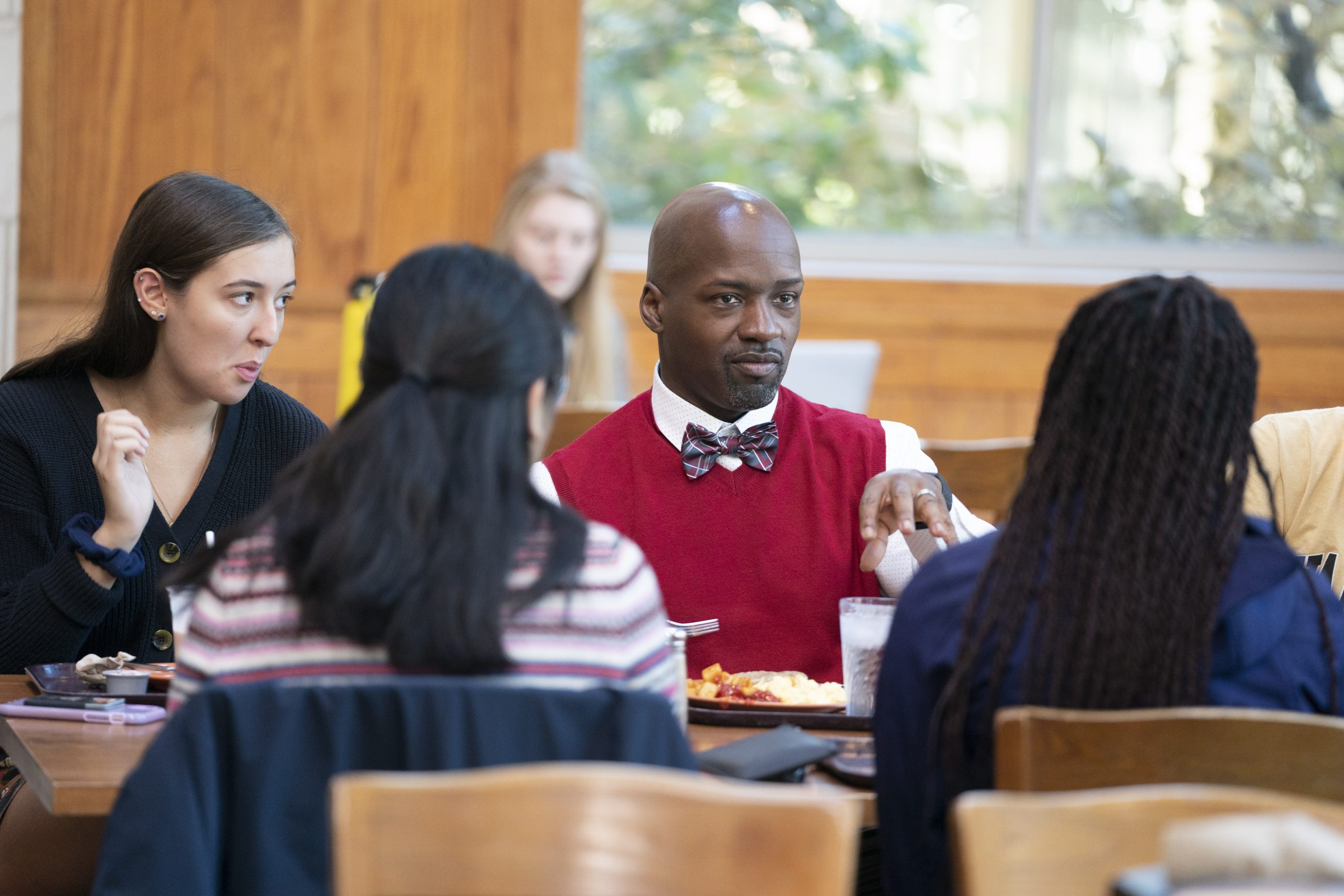 students in the dining hall with a professor
