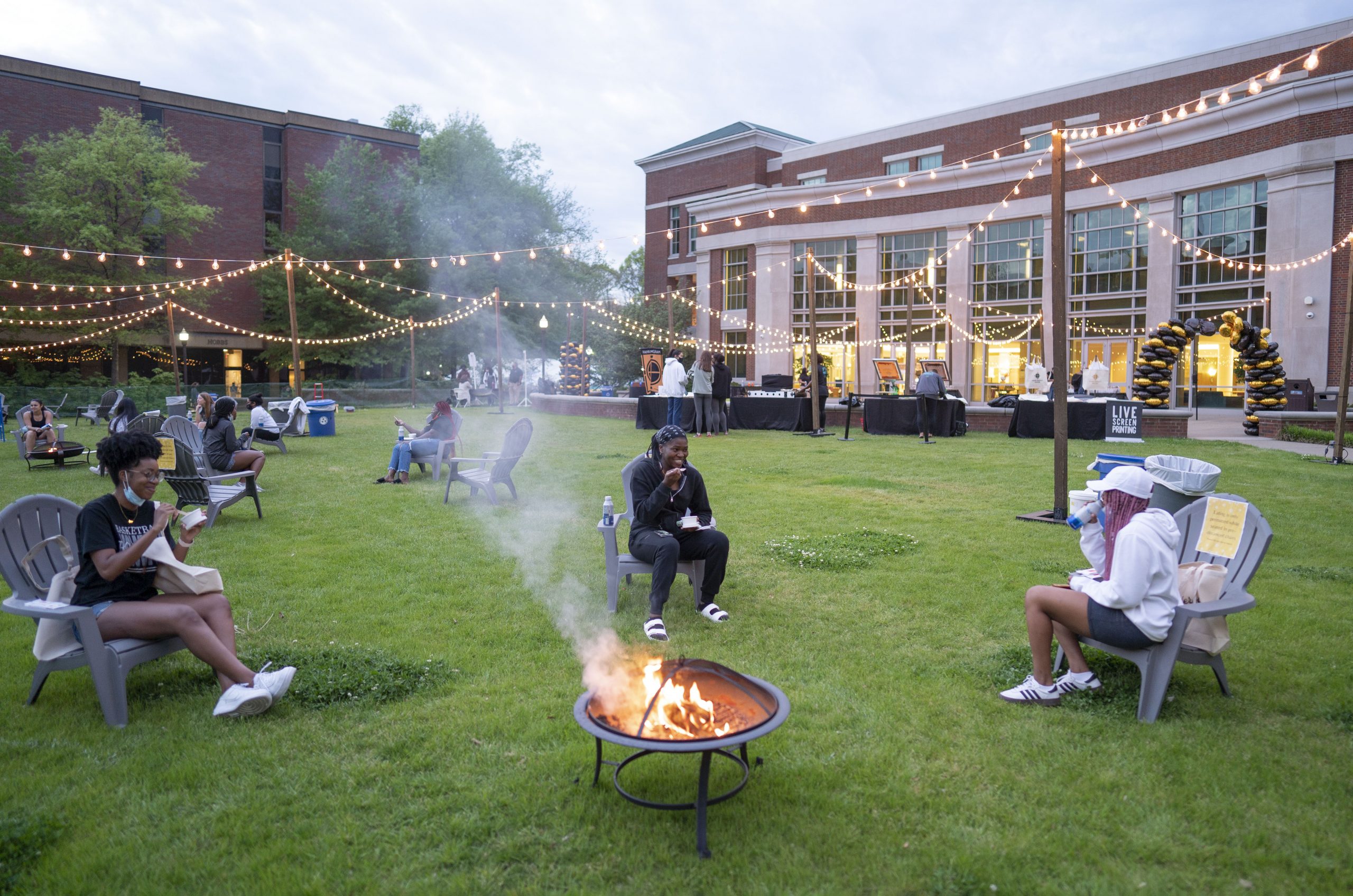 students gathered around a fire pit on The Commons