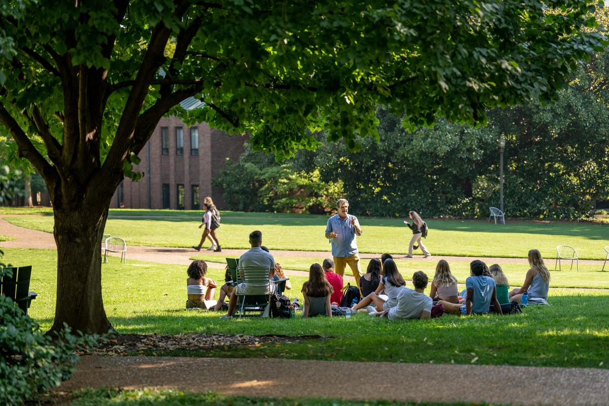 Vanderbilt students enjoy their first day of class outdoors on library lawn.