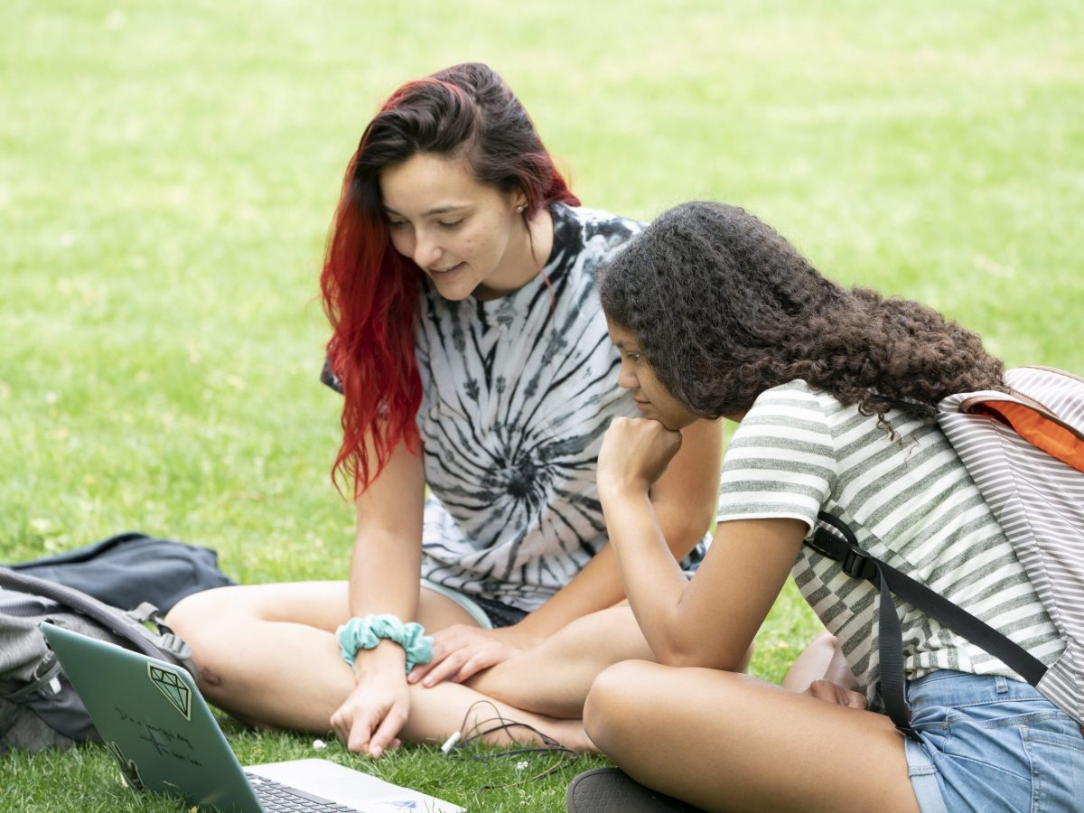 Campus general feature with students on campus enjoying nice weather. Spring, group, study, individual and play. Photo by Joe Howell