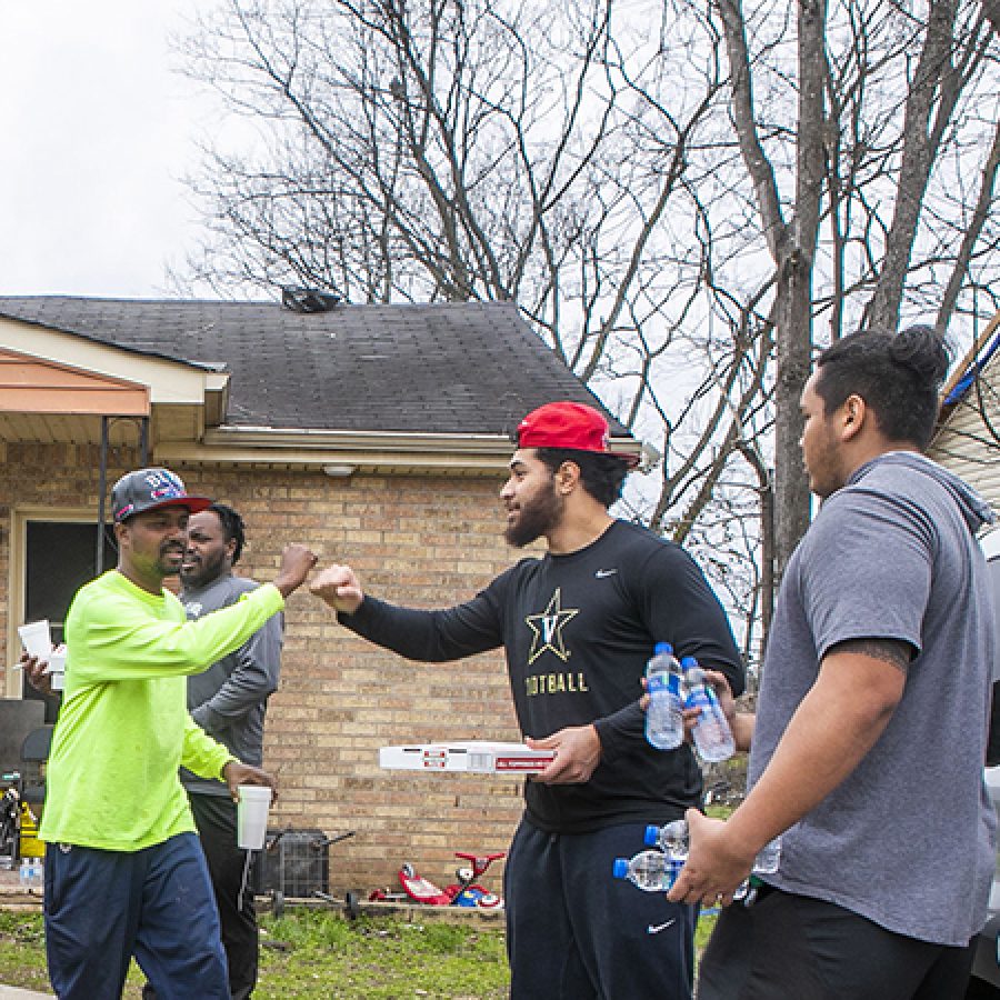 Vanderbilt senior, Mo Hasan, football teammates, and other students pass out meals and water for Nashville community in North Nashville after devastating tornado.  Vanderbilt University   Photo: Anne Rayner; VU